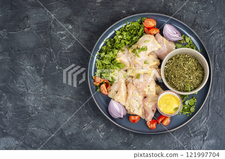 Raw chicken breast fillet with cilantro. 121997704