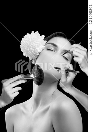 Conceptual art design. Faceless model with hands holding makeup brush, mascara wand, and lipstick showcasing intricate beauty techniques. Conceptual art design. Faceless model with hands holding makeup brush, mascara wand, and lipstick showcasing intricate beauty techniques. 121998861
