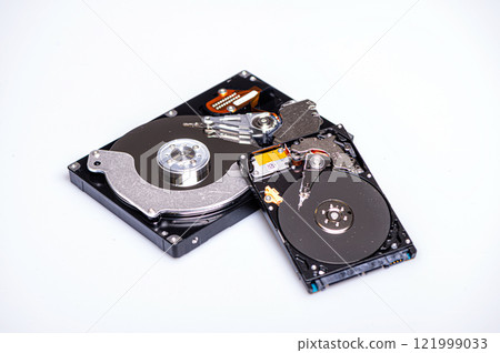 Close up inside of computer hard disk drive HDD isolated on white background Close up inside of computer hard disk drive HDD isolated on white background 121999033