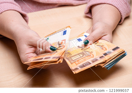 business, finance, saving, banking and people concept - close-up of woman hands counting euro money business, finance, saving, banking and people concept - close-up of woman hands counting euro money 121999037