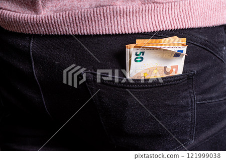 Euro banknotes in jeans back pocket. Concept of rich people, saving or spending money, closeup Euro banknotes in jeans back pocket. Concept of rich people, saving or spending money, closeup 121999038