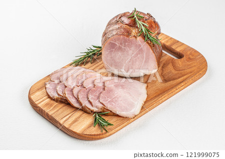 Delicious smoked ham on a wooden board. Cut Ham on a white background top view. copy space 121999075