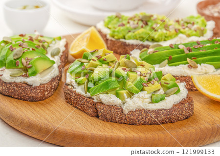 toast with avocado and cheese. Food recipe background. Close up. Clean eating, dieting, vegan food concept toast with avocado and cheese. Food recipe background. Close up. Clean eating, dieting, vegan food concept 121999133