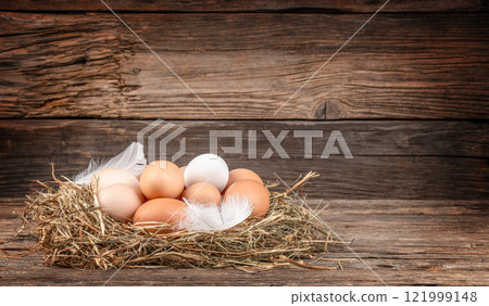 fresh eggs from the farm in the countryside, Chicken eggs in nest of straw on old wooden table background, copy space fresh eggs from the farm in the countryside, Chicken eggs in nest of straw on old wooden table background, copy space 121999148