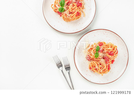 Delicious pasta with tomato sauce, basil and cheese on a light background, top view. copy space Delicious pasta with tomato sauce, basil and cheese on a light background, top view. copy space 121999178