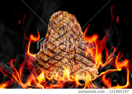 Beef T-bone steaks on BBQ grill coal. porterhouse steak or T Bone Steak with fire flames. Barbecue and grill concept Beef T-bone steaks on BBQ grill coal. porterhouse steak or T Bone Steak with fire flames. Barbecue and grill concept 121999197