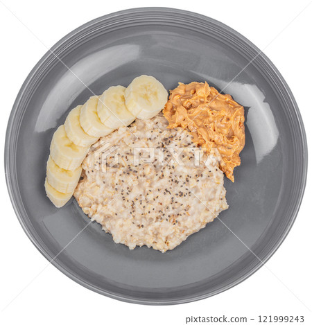 oatmeal porridge with banana and peanut butter isolated on white background. top view. nutritious and delicious breakfast 121999243