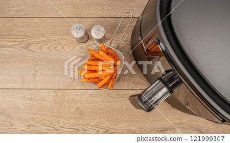 Homemade crispy sweet potato for air fryer oven on a wooden background. top view. copy space 121999307