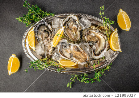 Oysters plate with lemon. Restaurant menu, dieting, cookbook recipe top view 121999327