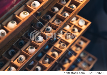 Wooden drawers filled with prosthetic eyeballs 121999646