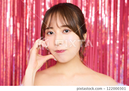 Fashion portrait of a young woman in a party room 122000301