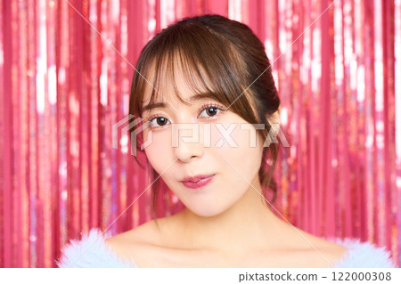 Fashion portrait of a young woman in a party room 122000308