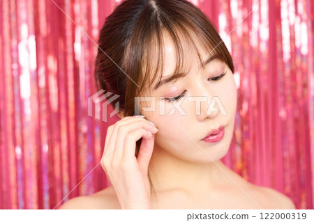 Fashion portrait of a young woman in a party room 122000319
