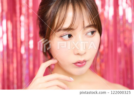 Fashion portrait of a young woman in a party room 122000325