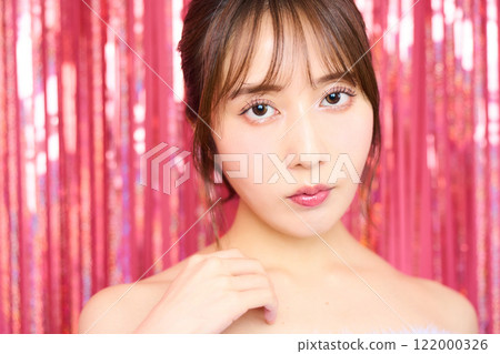 Fashion portrait of a young woman in a party room 122000326