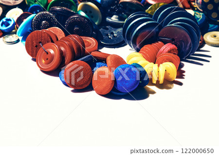 A large number of different multi-colored buttons and place for text A large number of different multi-colored buttons and place for text 122000650