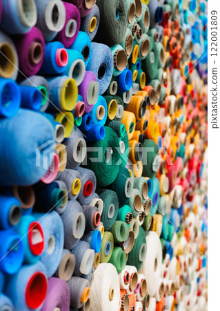 An Array of Colorful and Vibrant Spools of Thread Stacked Neatly in a Textile Shop Display An Array of Colorful and Vibrant Spools of Thread Stacked Neatly in a Textile Shop Display 122001809