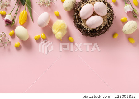Easter frame with pastel chocolate candy sweets, eggs, flowers, decorative nest, gypsophila and yellow chick on pink background. View from above. Flat lay. Happy Easter greeting card. Copy space. Easter frame with pastel chocolate candy sweets, eggs, flowers, decorative nest, gypsophila and yellow chick on pink background. View from above. Flat lay. Happy Easter greeting card. Copy space. 122001832