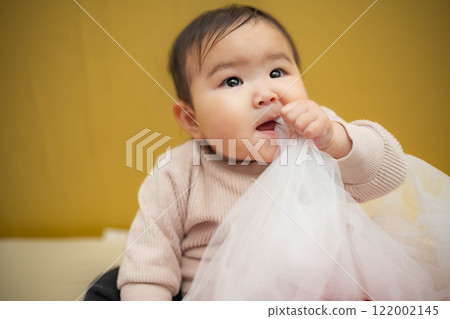 Baby playing with white cloth 122002145