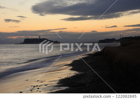 A view of Enoshima and the orange sunset from Shichirigahama Beach in Kamakura - Evening scenery 122002695