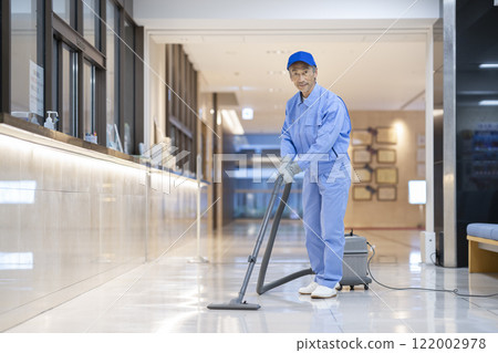 Senior cleaning staff cleaning the building 122002978