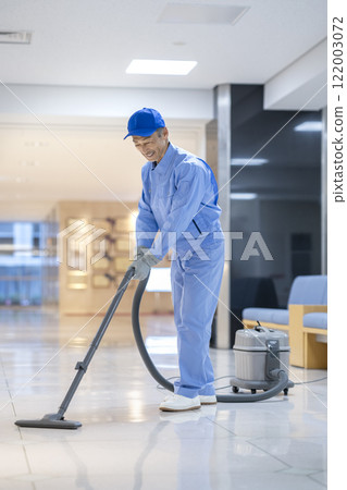 Senior cleaning staff cleaning the building 122003072