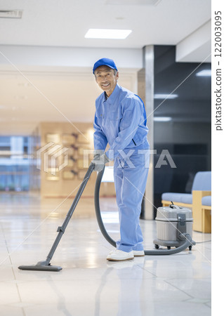 Senior man cleaning a building, smiling portrait looking at the camera 122003095
