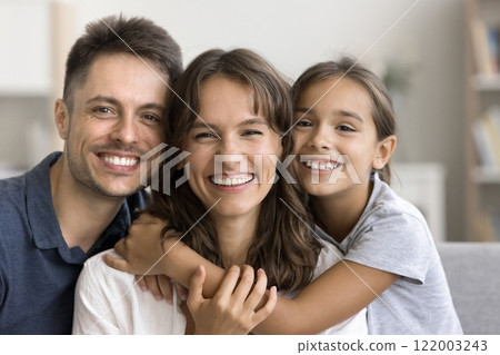 Authentic beautiful Latin parents and daughter smiling at camera Authentic beautiful Latin parents and daughter smiling at camera 122003243
