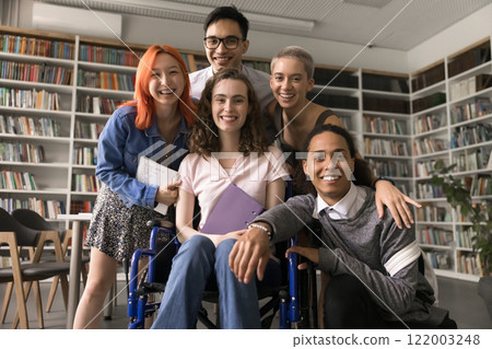 Happy diverse students team gather in library for group portrait 122003248