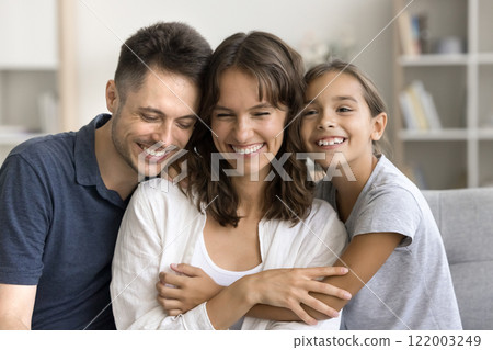 Little daughter enjoy moment of tenderness with loving parents Little daughter enjoy moment of tenderness with loving parents 122003249