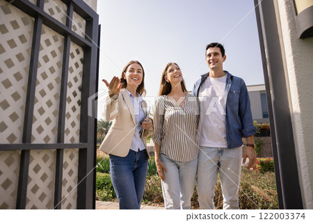 Positive real estate professional agent inviting renters to come 122003374