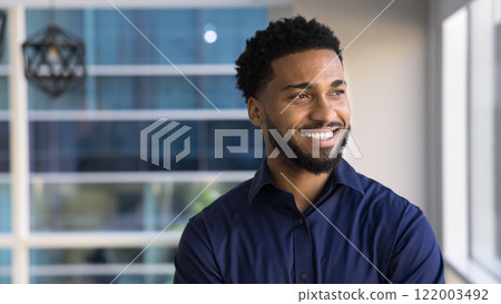 Happy dreamy African business leader man looking at window away 122003492