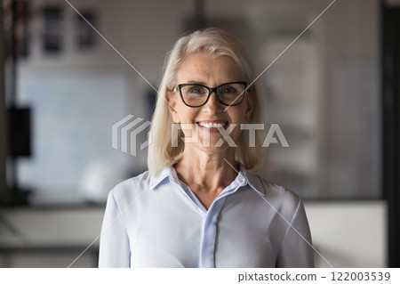 Head shot portrait pretty Caucasian mature businesslady posing in office 122003539