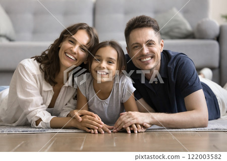 Portrait of happy wellbeing family with daughter posing for camera Portrait of happy wellbeing family with daughter posing for camera 122003582