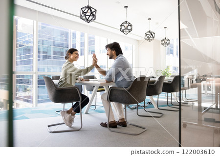 Happy Indian coworkers celebrating business success, successful cooperation 122003610