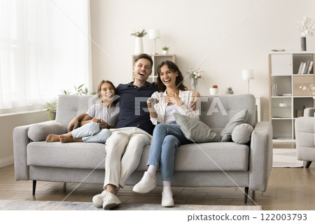 Family members, laughing, watching comedy movie or educational program Family members, laughing, watching comedy movie or educational program 122003793