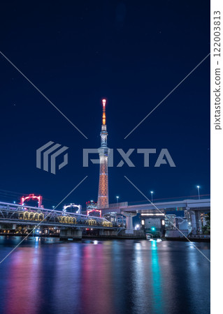 Illuminated bridge and Skytree seen from the Sumida River 122003813