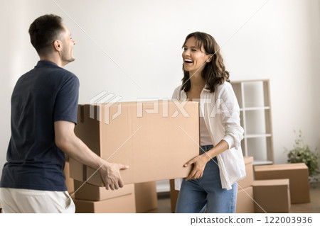 Couple bring their personal belongings packed in big cardboard boxes Couple bring their personal belongings packed in big cardboard boxes 122003936