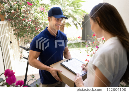 Customer woman signing receiving confirmation document for courier 122004108