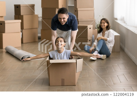 Father pushing carton box with small daughter on relocation day 122004119