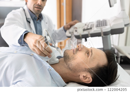 Clinic patient man lying on couch on ultrasound scanning procedure 122004205