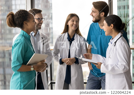 Clinic staff laughing, take break, engaged in friendly conversation 122004224