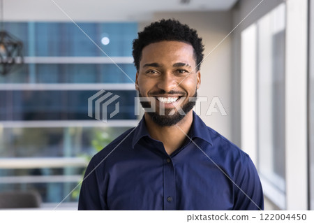 Cheerful handsome young African American businessman posing for head shot 122004450