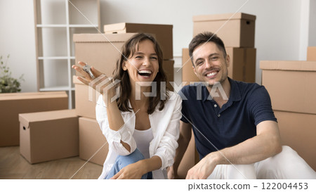 Couple showing at camera bunch of keys from new house 122004453