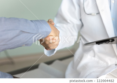 Cropped shot of male doctor and patient shaking hands Cropped shot of male doctor and patient shaking hands 122004482