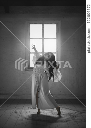 Woman with long dark hair, flowing white dress, black claws stands in dramatic pose, expressing supernatural allure, mysticism. Black and white photography 122004572