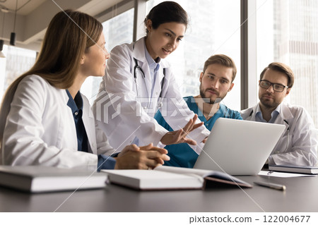 Group of skilled medical workers in uniforms engaged in teamwork 122004677