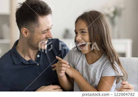Excited happy father tickling joyful preschooler daughter 122004782