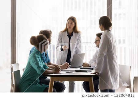 Diverse young healthcare specialists take part medical concilium 122004912