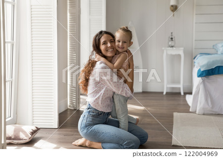 Portrait happy young mother holding preschool daughter child in arms 122004969